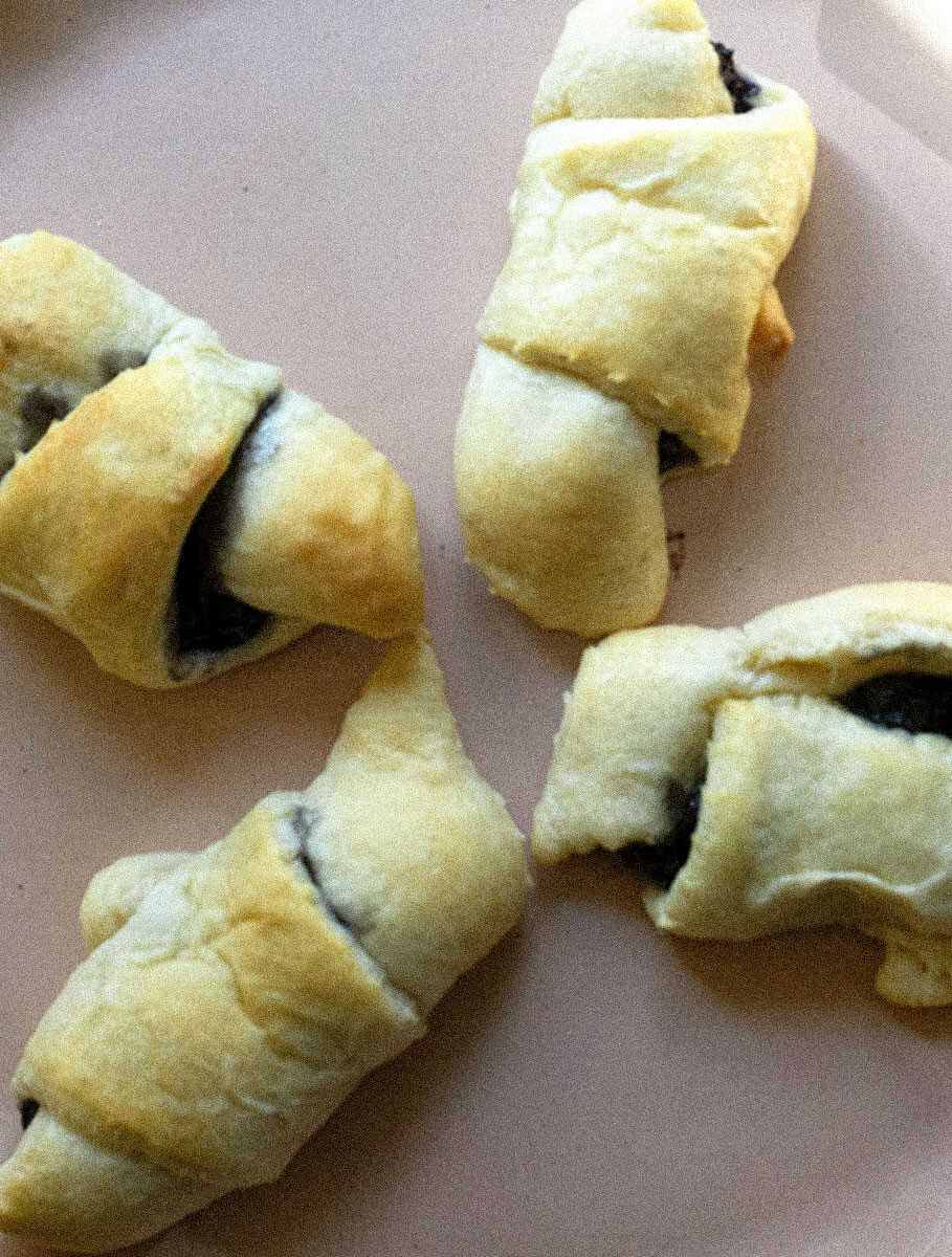 BlueberryCroissant1-1 blueberry croissant on white plate.
