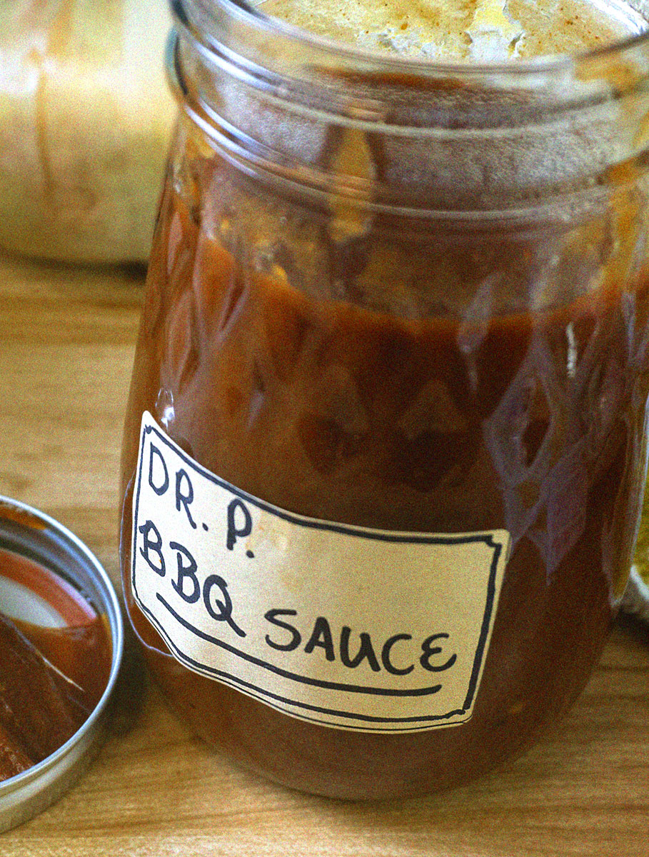 DrPBBQSauce1-1 Glass mason jar with sauce on wooden cutting board with brush