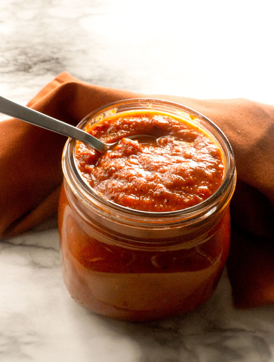 PizzaSauce2-2 Pizza Sauce on marble countertop with silver spoon, with red nakpin