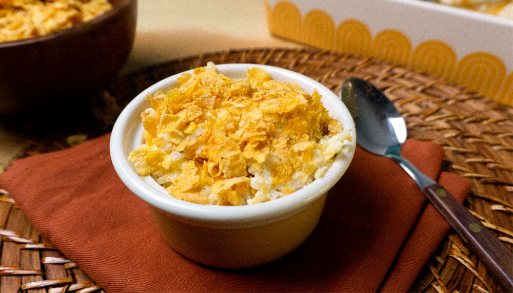 Funeral Potatoes on red napkin, with spoon with wooden handle