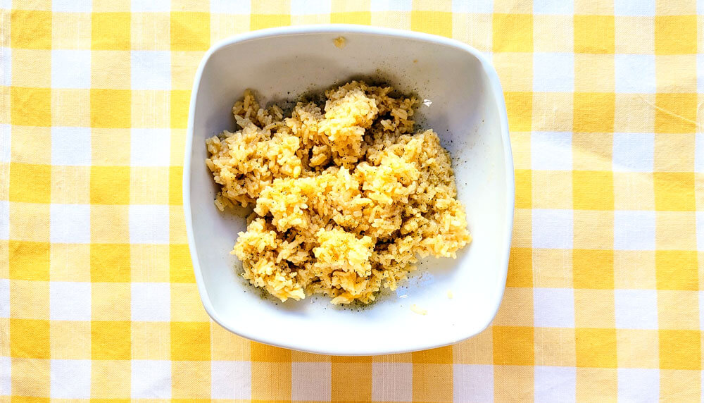 Rice in white bowl on yellow checkered pattern yellow and white