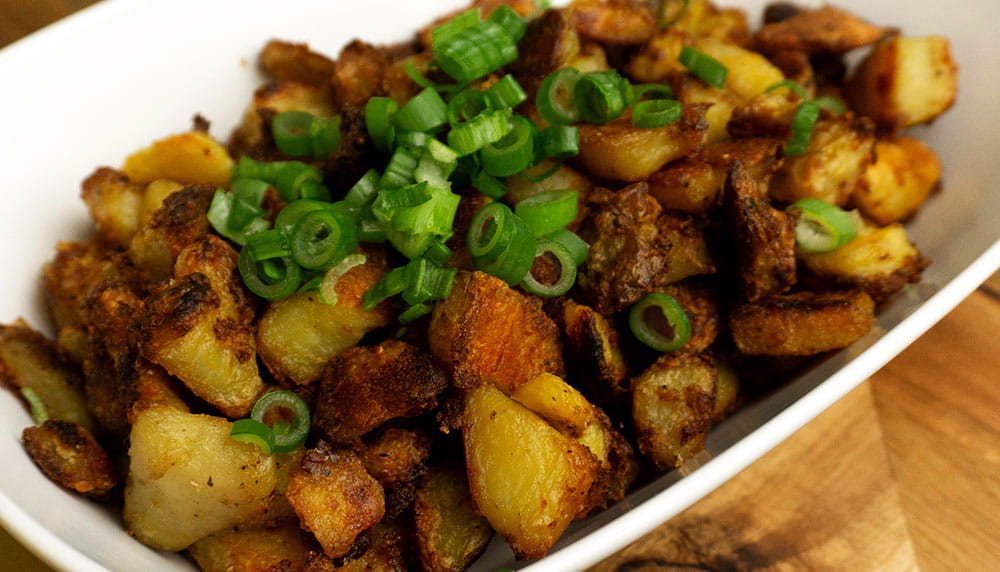 Crispy Potato in a while retangle bowl on a wooden board