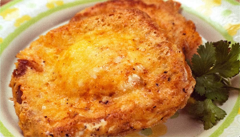 egg in a basket on yellow and green plate.